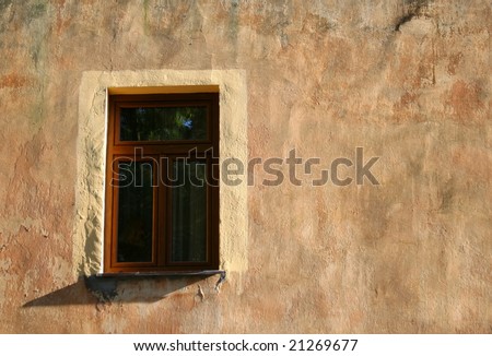 The only window in old painted wall