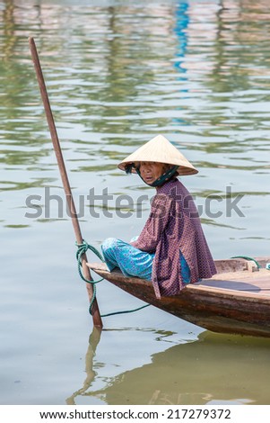 HOI AN, VIETNAM - MARCH 31: Woman driving the fishing boat in Hoi An, Vietnam on March 31, 2014.