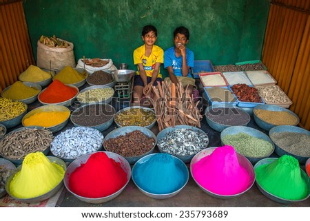 GOKARNA, KARNATAKA, INDIA - JANUARY 19, 2013: Unidentified boys sell dye powder and spices on the street market on January 19, 2013 in Gokarna, Karnataka, India.
