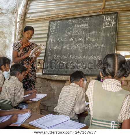 HAMPI, KARNATAKA, INDIA - FEBRUARY 1, 2013: Unidentified children attending lesson at a small classroom in the rural area of Hampi, Karnataka, India on February 1, 2013.