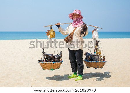 Phuket, Thailand - January 26,2015: Thai woman selling beachwear and souvenirs at beach in Phuket, Thailand.