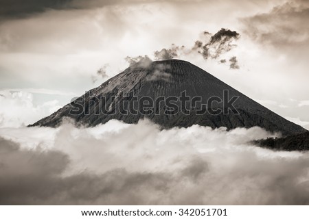 Ash cloud rising at Semeru Volcano Mountain, East Java, Indonesia. Black and white dramatic photo