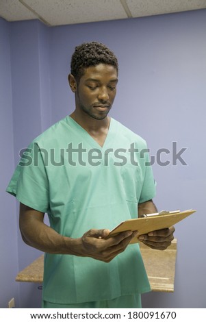 vertical, color image of an african american doctor reading charts