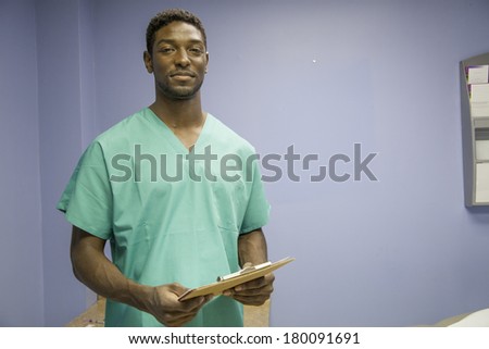 horizontal, color image of an african american doctor reading charts