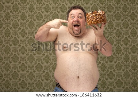 horizontal, color image of an overweight male happy and smiling holding a cake in his hand