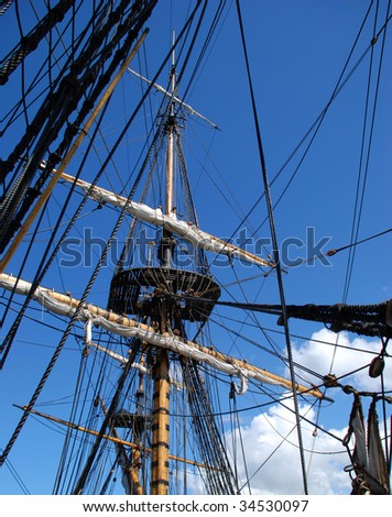Sky. Mast ship. A lot of rope.