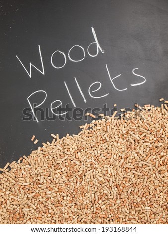 wood pellets on  a blackboard with the words wood pellets written in white chalk