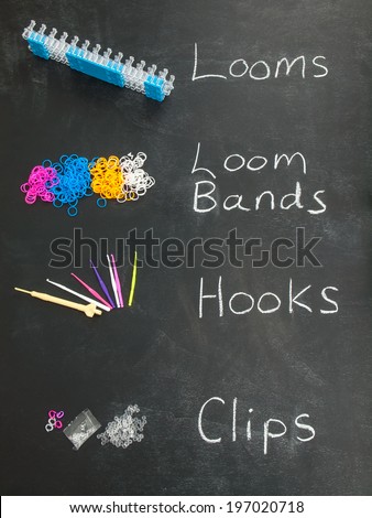 loom bands and looming tools on a blackboard with the text looms, loom bands, hooks and clips