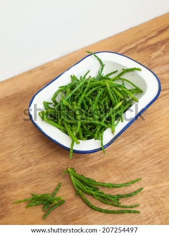 dish full of fresh green rock samphire. samphire, a naturally occurring coastal green, is a traditional accompaniment for fish and is again growing in popularity in northern europe.