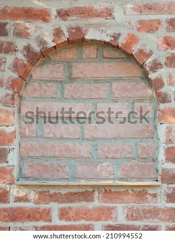 detail of decorative portal in a red brick wall