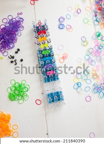band loom and colorful elastic bands against a white table top