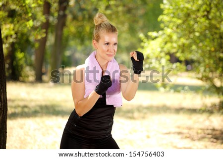 Girl in boxing guard exercise in the park 1