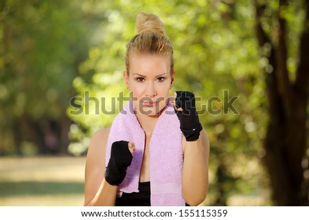 Girl in boxing guard exercise in the park 3
