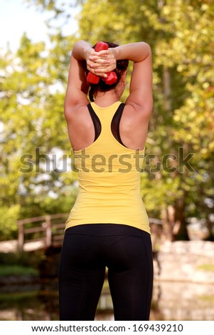Young Woman Aerobics Instructor with set of weights