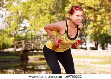 Young Woman Aerobics Instructor with set of weights 3