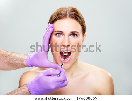 Mouth care,Close-up of female with open mouth during oral checkup at the dentistÃ¢Â?Â?s