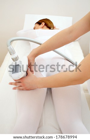 Woman having a treatment against cellulite with  machine in beauty salon 3