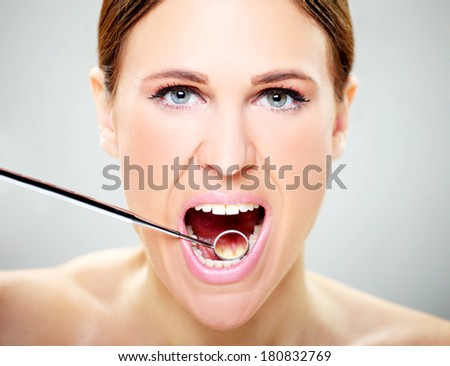 Mouth care,Close-up of female with open mouth during oral checkup at the dentist