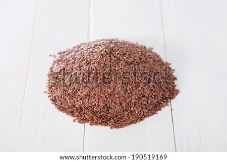 pile of flax seed on old white tab