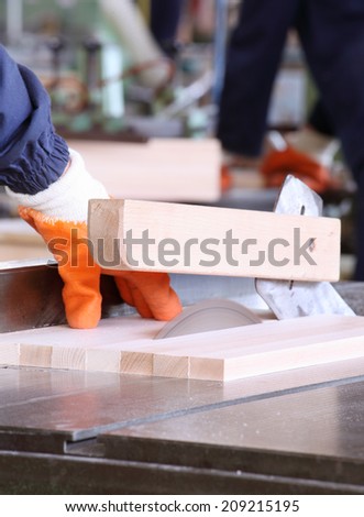 male carpenter using table saw for cutting wood 6