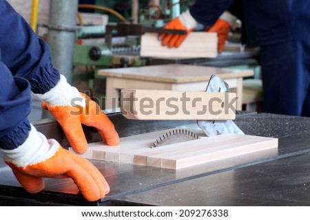 male carpenter using table saw for cutting wood 5
