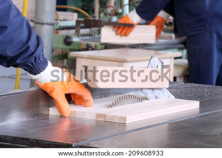 male carpenter using table saw for cutting wood 4