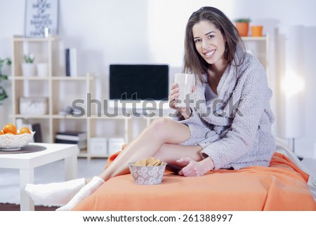 Beautiful woman in bed having tablet, computer and laughing, Woman in bed text messages with  tablet and laughing in living room, Woman in bed taking selfie with phone