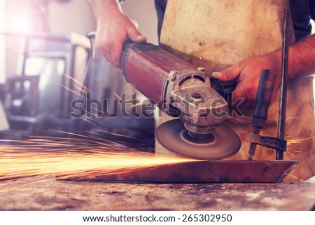 Man Grinding in workshop,shallow depth of filed