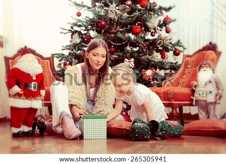 Mother and daughter opening Christmas presents,shallow depth of field