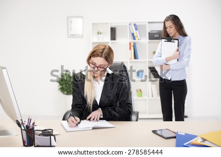 Two business women in office. Boss and employee