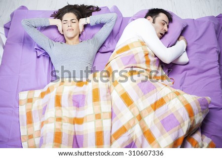 Snoring man. Couple in bed, man snoring and woman can not sleep,