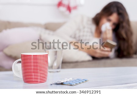 Sick Woman, Flu Woman. Caught Cold. Woman with headache typing on cell phone, shallow depth of field