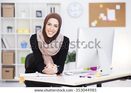 Beautiful Arabic business woman working on computer. Woman in her office,shallow depth of field