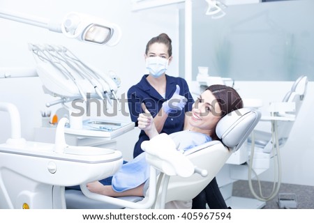 Beautiful woman patient having dental treatment at dentist\'s office. Woman visiting her dentist