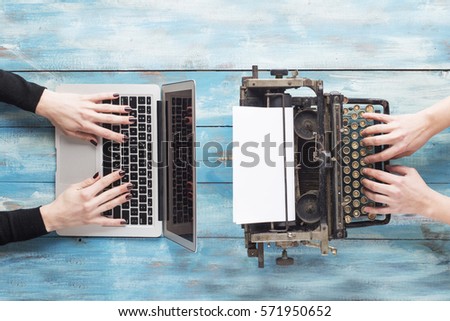 Old typewriter and laptop. Concept of technology progress