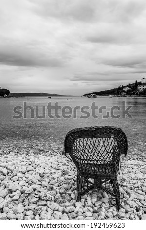 Chair on a beach covered with pebbles, Santa Marina, Istra, Croatia