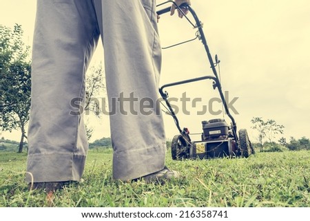 Person mowing a lawn shot from ground level