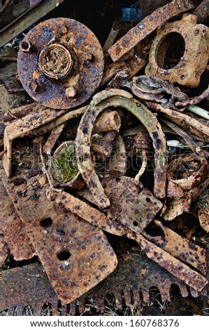 Rusty antique horseshoe with other old metal automotive parts. Rusty Antique Horseshoe with metal parts