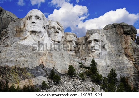 Mt. Rushmore National Memorial Park In South Dakota With Bright Blue Sky In Background. Sculptures Of Former U.S. Presidents; George Washington,Thomas Jefferson,Theodore Roosevelt And Abraham Lincoln.