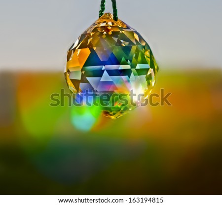 Crystal  Ball in window reflecting colored light/Crystal in Window/Crystal Ball in window captures brilliant colored reflections of sunlight