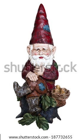 Gnome in red hat and outfit sitting on a tree stump with his legs crossed. Gnome with red hat sitting on a tree stump