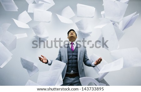 Busy Businessman With Pile Of Papers Flying On Air