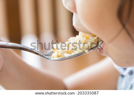 closeup Little girl eating rice