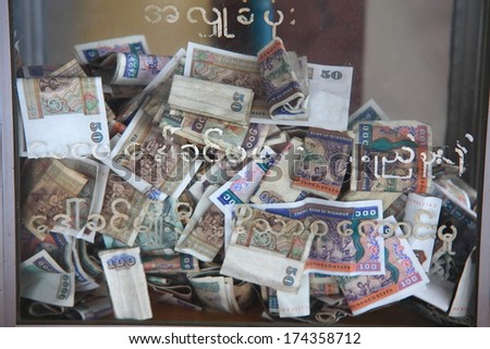 Myanmar Kyats bank notes background in the donation box