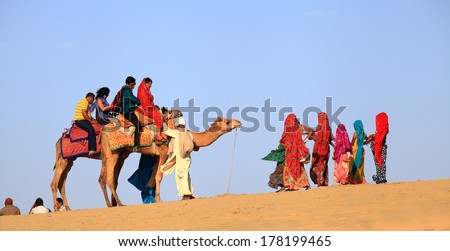 Jaisalmer, India - February 25, 2013: Camel Riding At The Sam Sand Dune. The Activity Is Part Of The Desert Festival Held In Winter To Attract Both Domestic And International Tourists.
