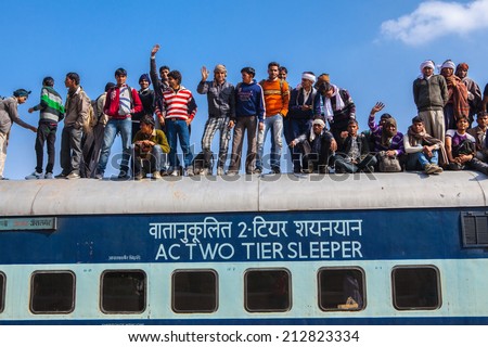 JAISALMER, INDIA - FEBRUARY 23: Unknown Indian men on the train on February 23, 2013 in Jaisalmer, India.The Great Railway Transport System ,Indian railways transport 20 million passengers daily.