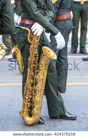 Marching Band Performers are waiting for Playing Baritone saxophone in Parade