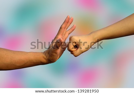 Hands ready for any impact on colorful background, strong hands, fist hands