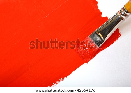Brush with red paint and red brush on the white background