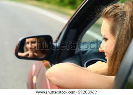 young woman in a red car